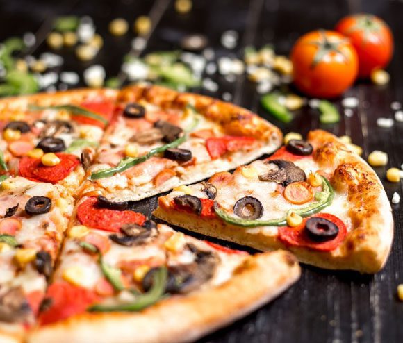 Close-up-of-pepperoni-pizza-slices-with-sausages-mushroom-olive-bell-pepper-and-cheese